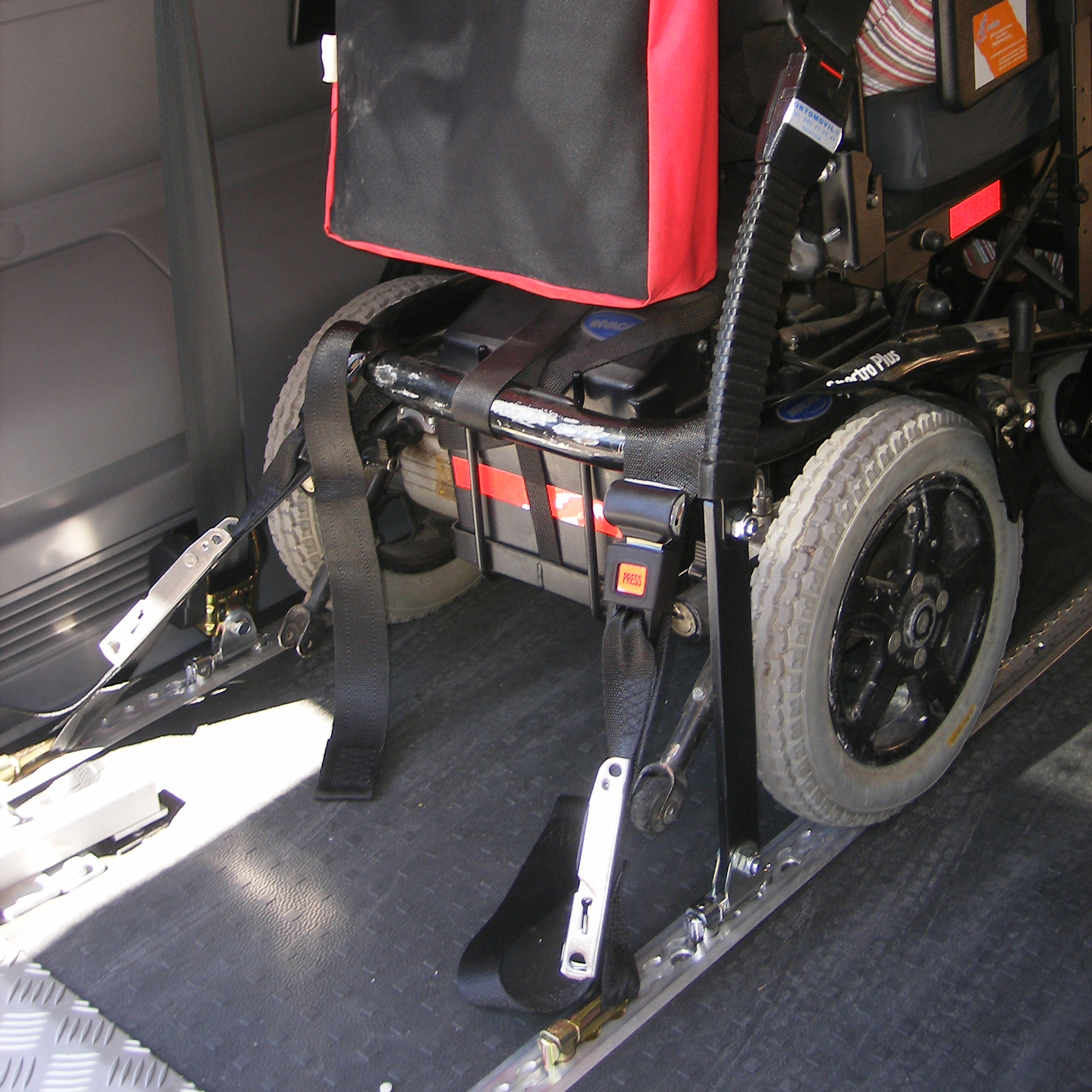 Silla de ruedas sujeta a los anclajes de seguridad de una furgoneta adaptada