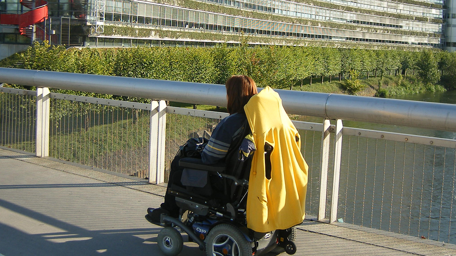 Mujer en silla de ruedas paseando por un puente